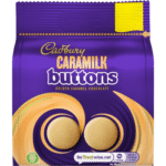 Cadbury Caramilk Golden Caramel Buttons 90g bag – creamy caramelised white chocolate buttons available at Mart Subhani Dundee